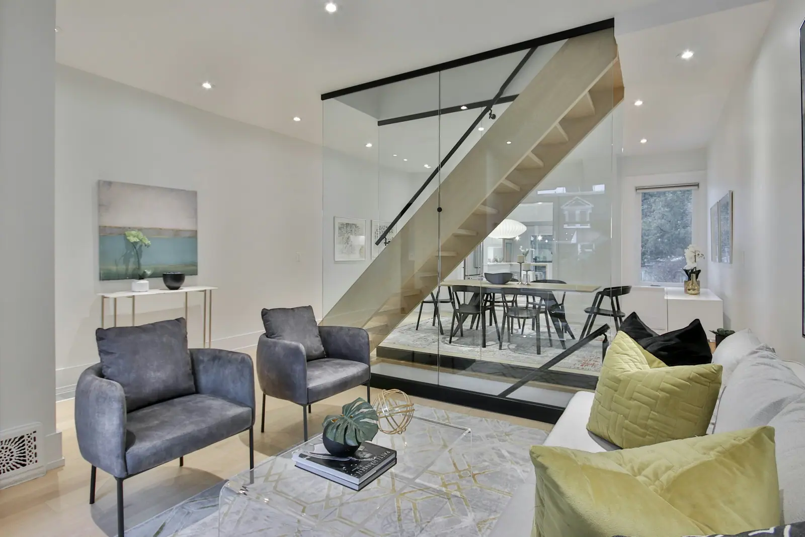 Interior staircase with a glass railing and a seating area